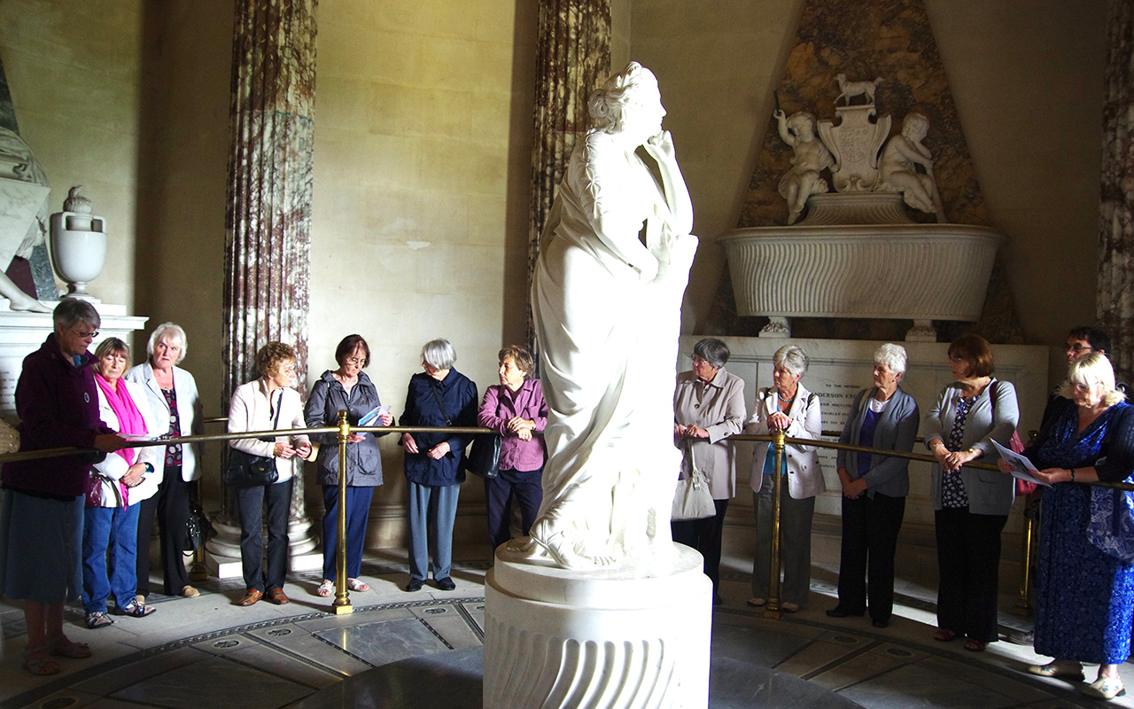 Group of Georgian Society visitors standing around a statue at the Mausoleum, Brocklesby, Lincolnshire