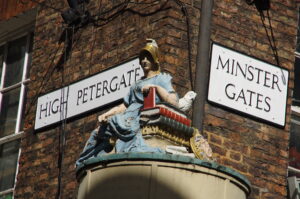 Painted statue of Minerva at the corner of High Petergate and Minster Gates in York.